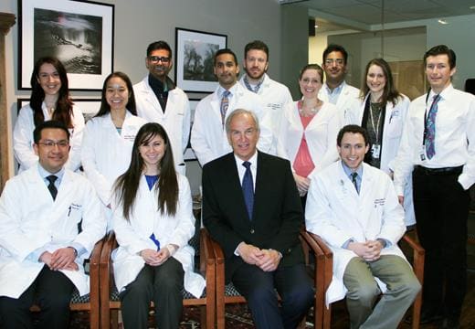 Randolph Sherman, MD, FACS seated with several residents.