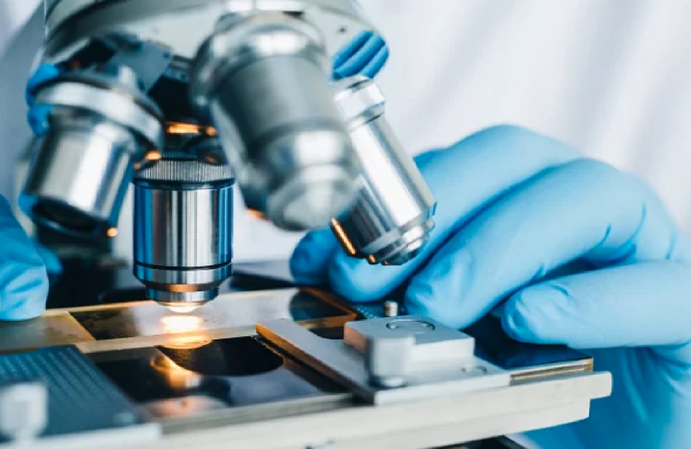 Close-up shot of microscope with metal lens at laboratory.